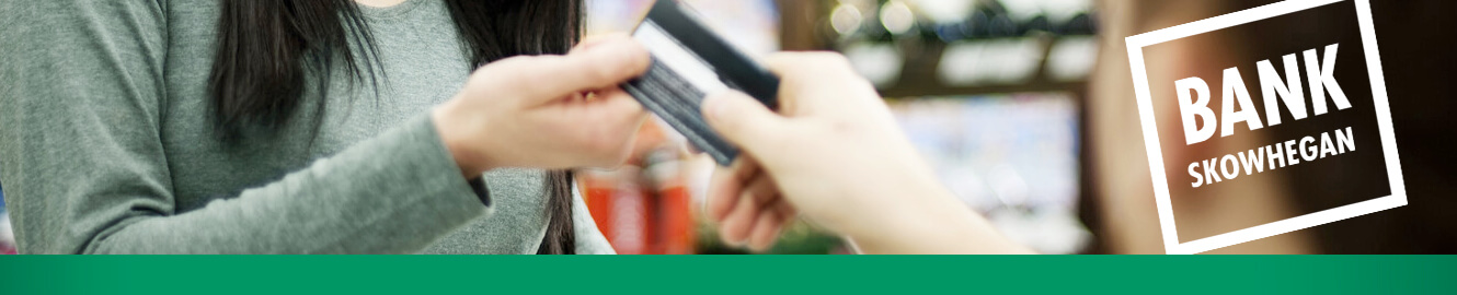 Person handing someone their debit card and text saying, "Bank Skowhegan"